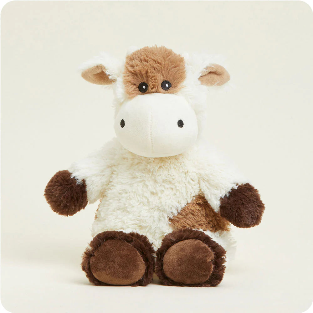 Warmies microwavable Cow stuffed animal toy with soft plush fabric, designed for warmth and comfort.