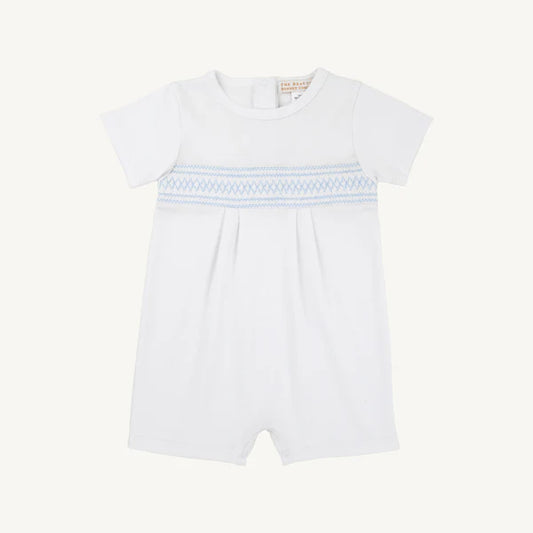 Baby girl wearing the Worth Ave Sebastian Smocked Romper by The Beaufort Bonnet Company, featuring white and Beale Street Blue colors.