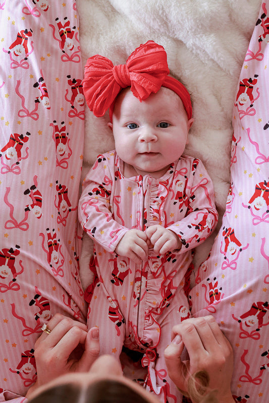 Caden Lane Jolly Ribbons Christmas Ruffle Zipper Footie for babies, featuring festive red and white ribbon pattern and cozy fabric.