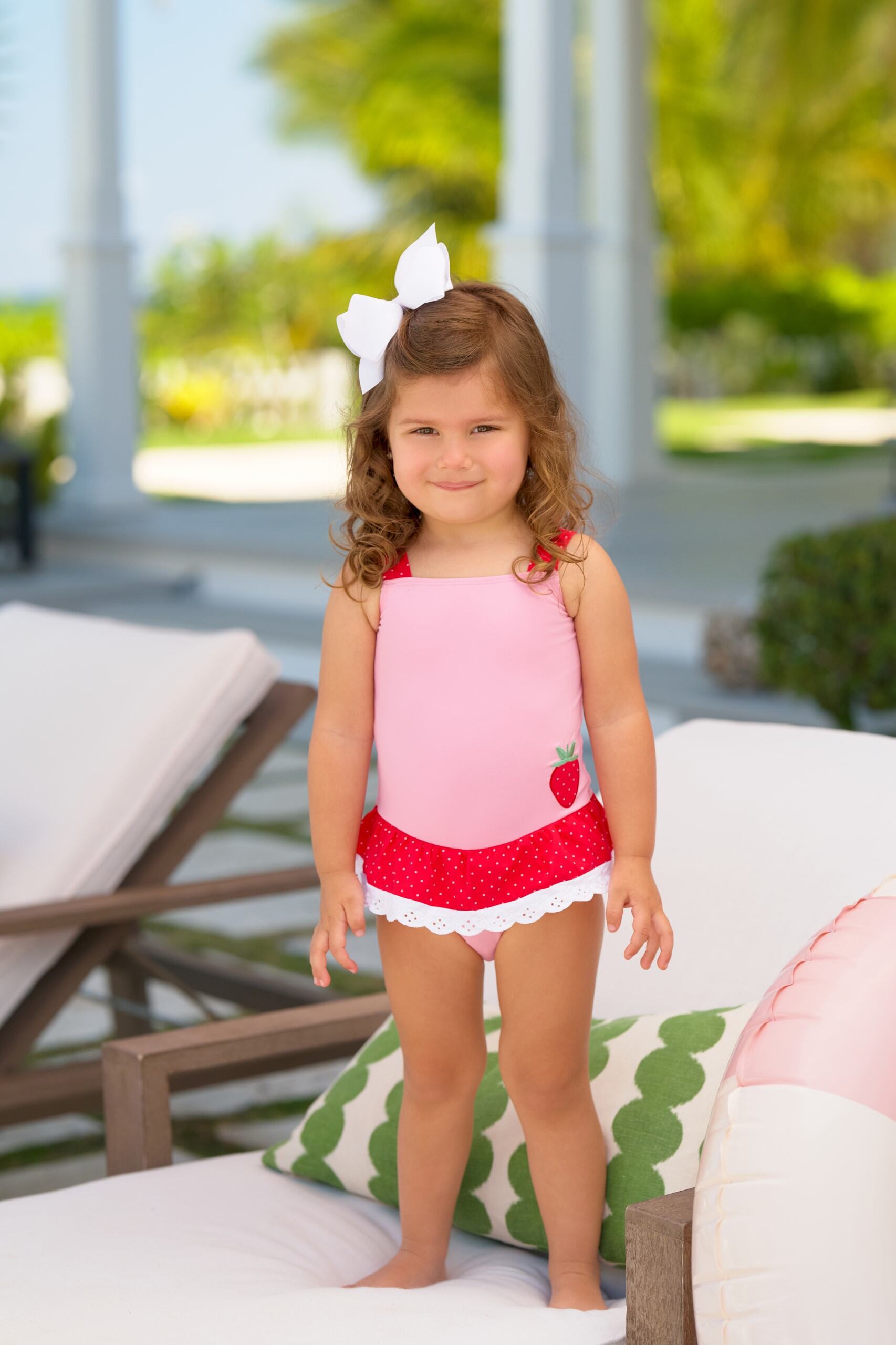 Hamptons hot pink, Richmond red, and Strawberry Grace Bay bathing suit by The Beaufort Bonnet Company, shown on a child.