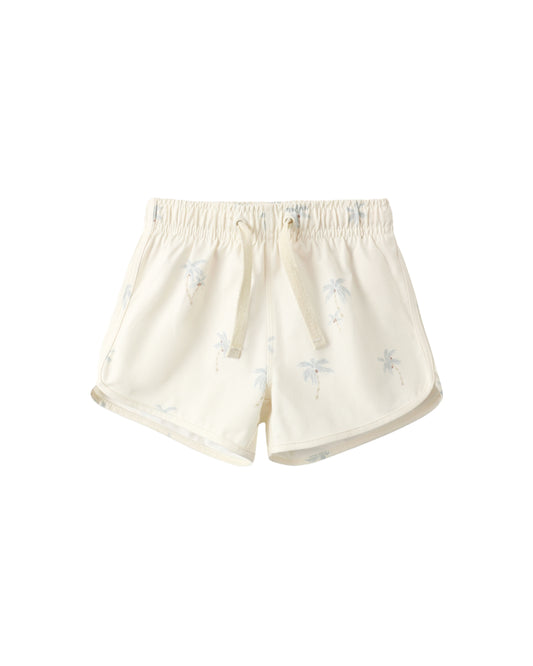 Rylee & Cru Palms Swim Trunk featuring a vibrant palm leaf print and comfortable elastic waistband.