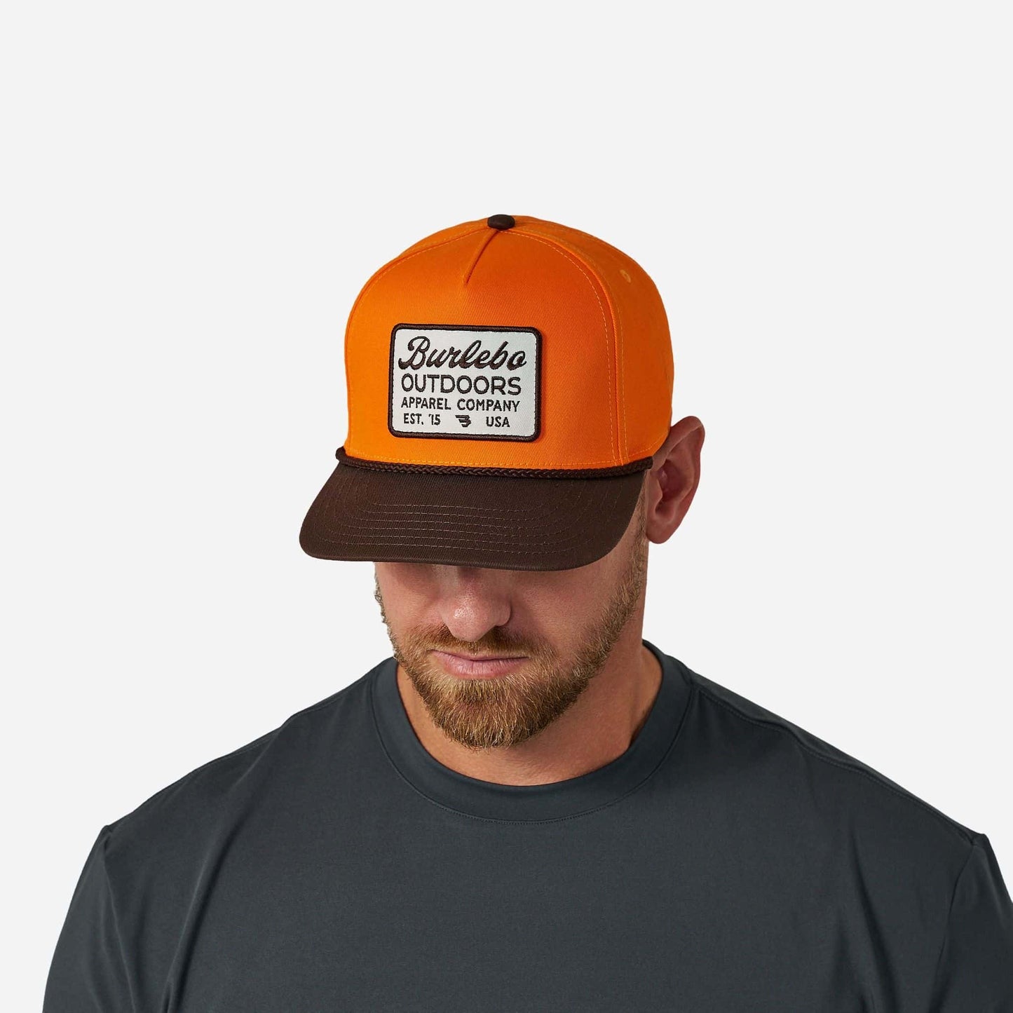 Youth Blaze Outdoors Cap by Burlebo, featuring a lightweight design and adjustable strap, shown in a vibrant outdoor setting.