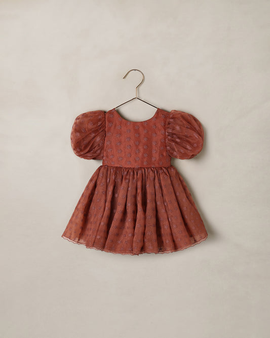 Noralee Spice Floral Sofia Dress displayed on a hanger, featuring vibrant floral patterns and lightweight fabric.