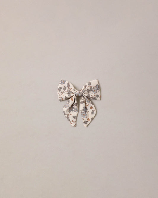 Blue Garden Norah Bow by Noralee, a stylish fabric hair accessory with a floral garden pattern and elegant bow design.