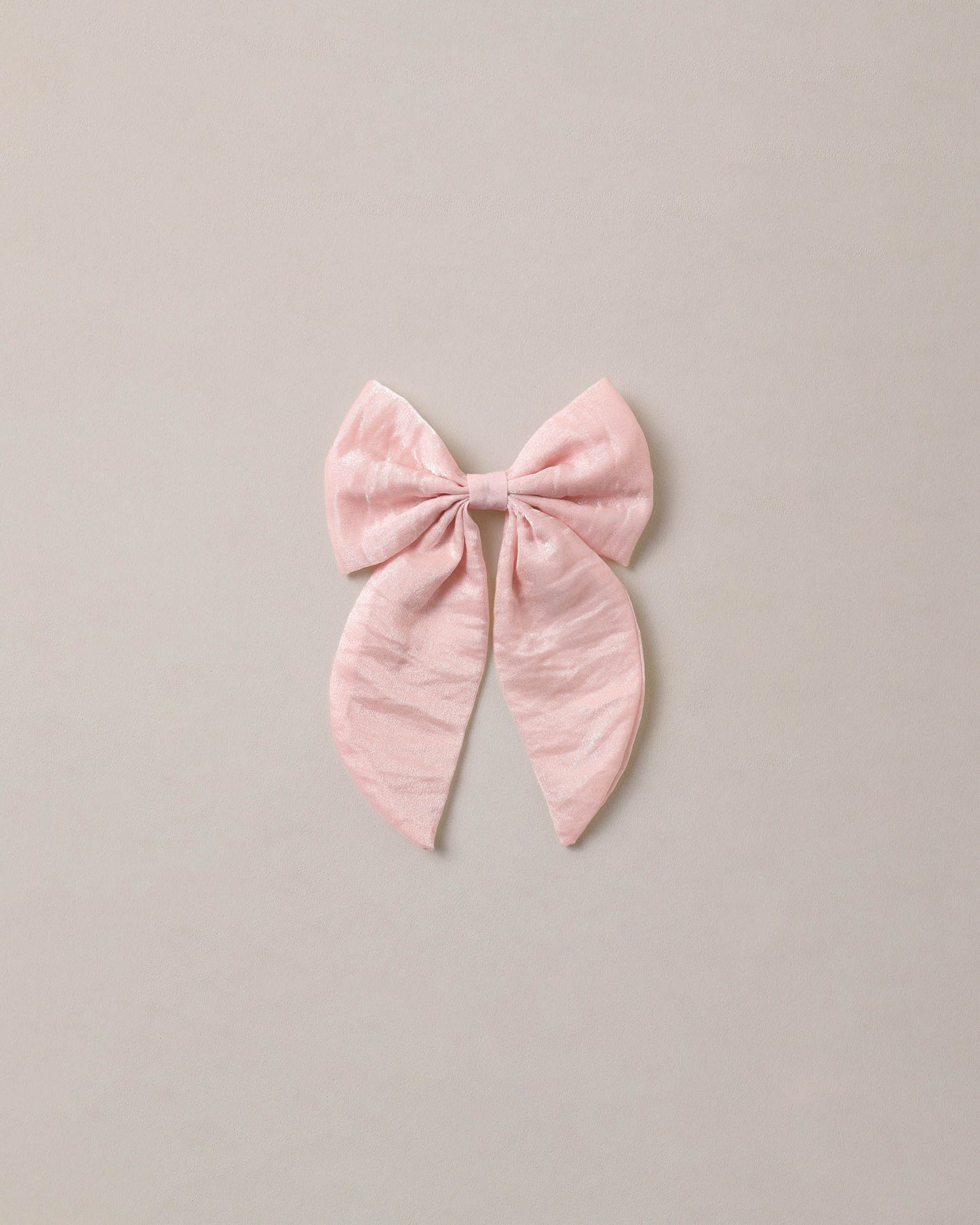Noralee Rose Shimmer Everly Bow, a stylish hair accessory with a shimmering rose design and elegant bow detail.