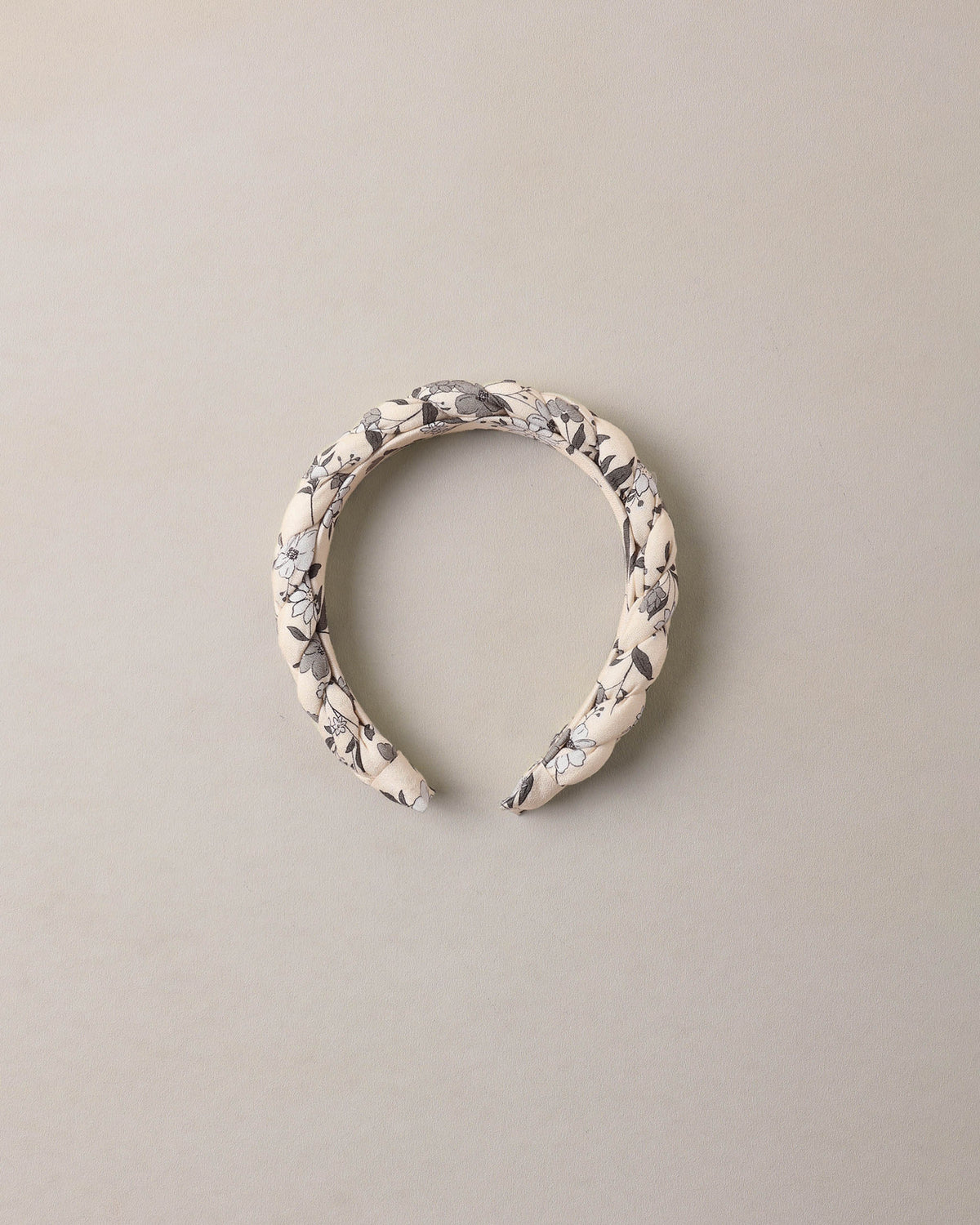 Blue braided garden headband by Noralee, featuring woven fabric with floral-inspired design and casual styling.