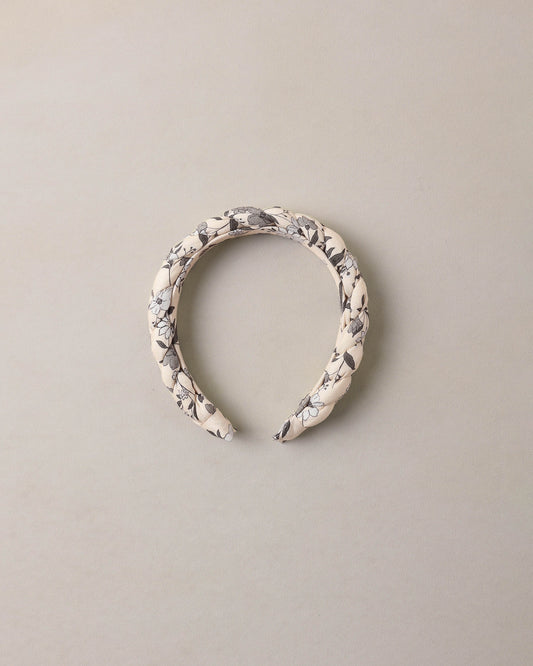Blue braided garden headband by Noralee, featuring woven fabric with floral-inspired design and casual styling.