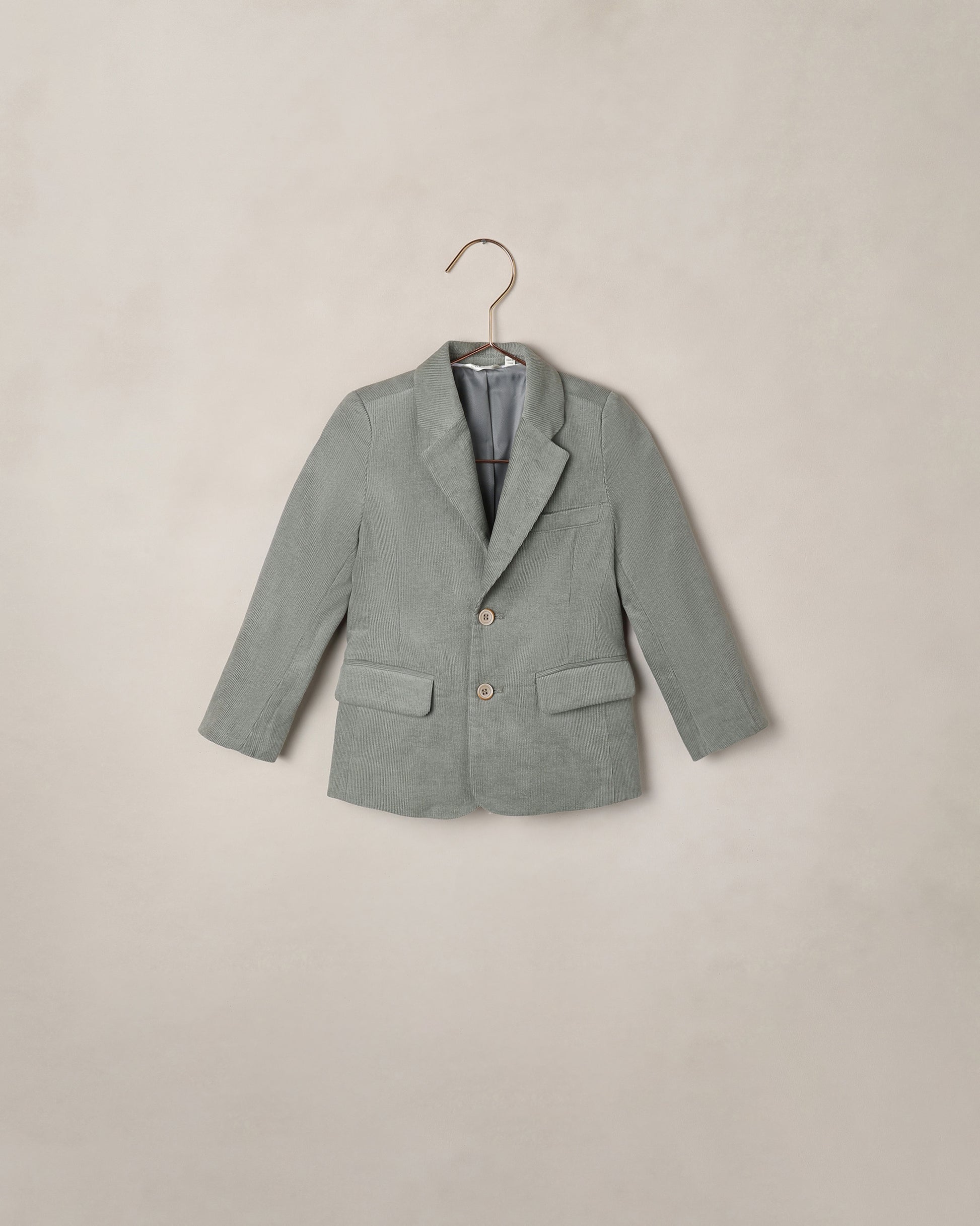 Noralee Eucalyptus Sebastian Blazer shown on a model, featuring tailored design with lapels, front buttons, and long sleeves.