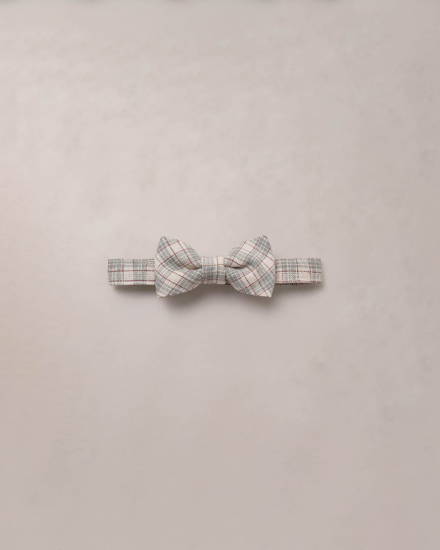 Noralee fall plaid bow tie featuring a classic red, black, and white checkered pattern, perfect for stylish seasonal outfits.
