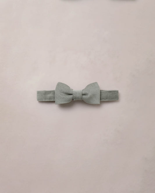 Eucalyptus-themed bow tie by Noralee featuring a green foliage pattern on fabric, stylish accessory for formal attire.