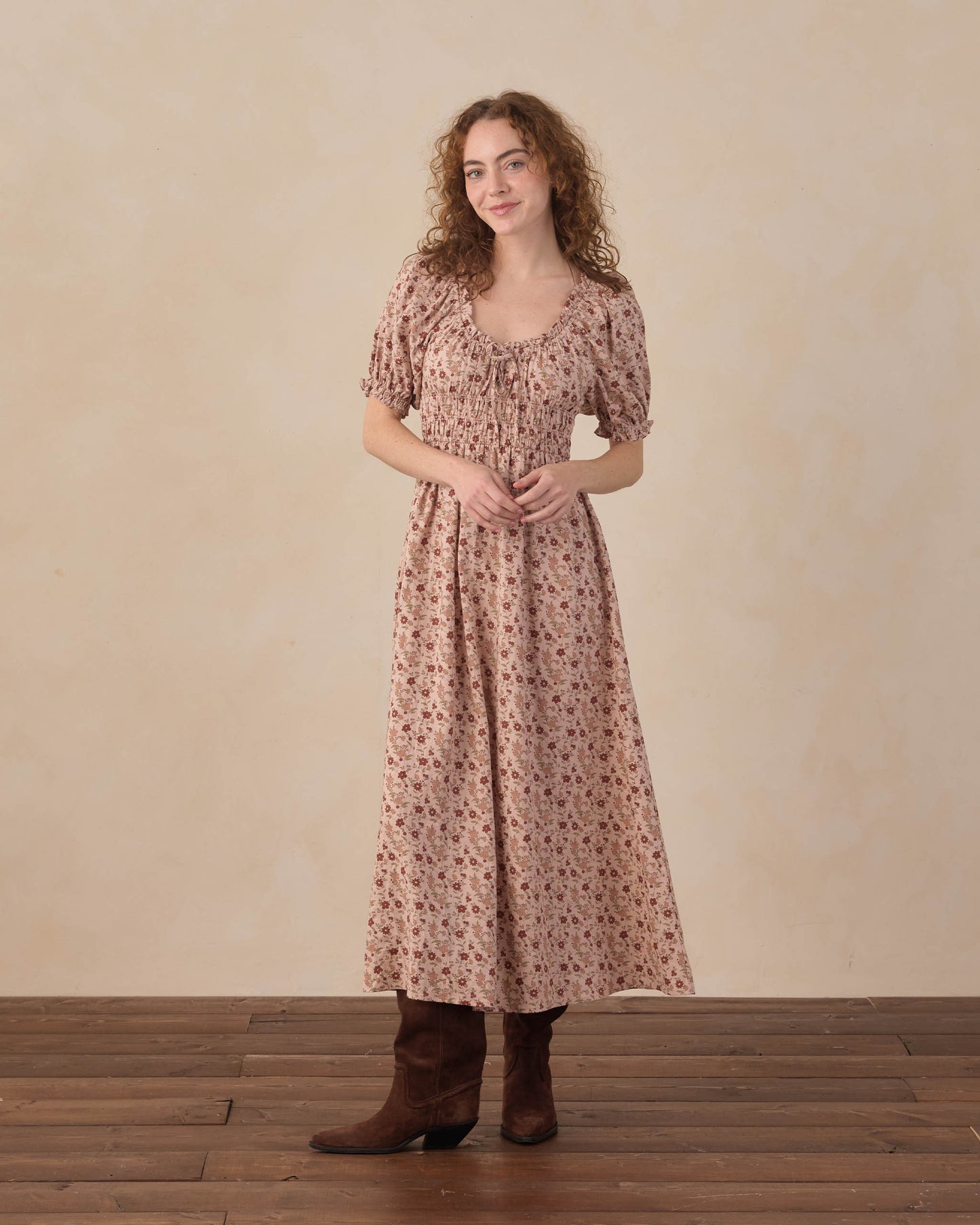 Women's pink floral Haisley dress by Rylee & Cru, featuring a flowy fabric and vibrant floral pattern on a sunny background.
