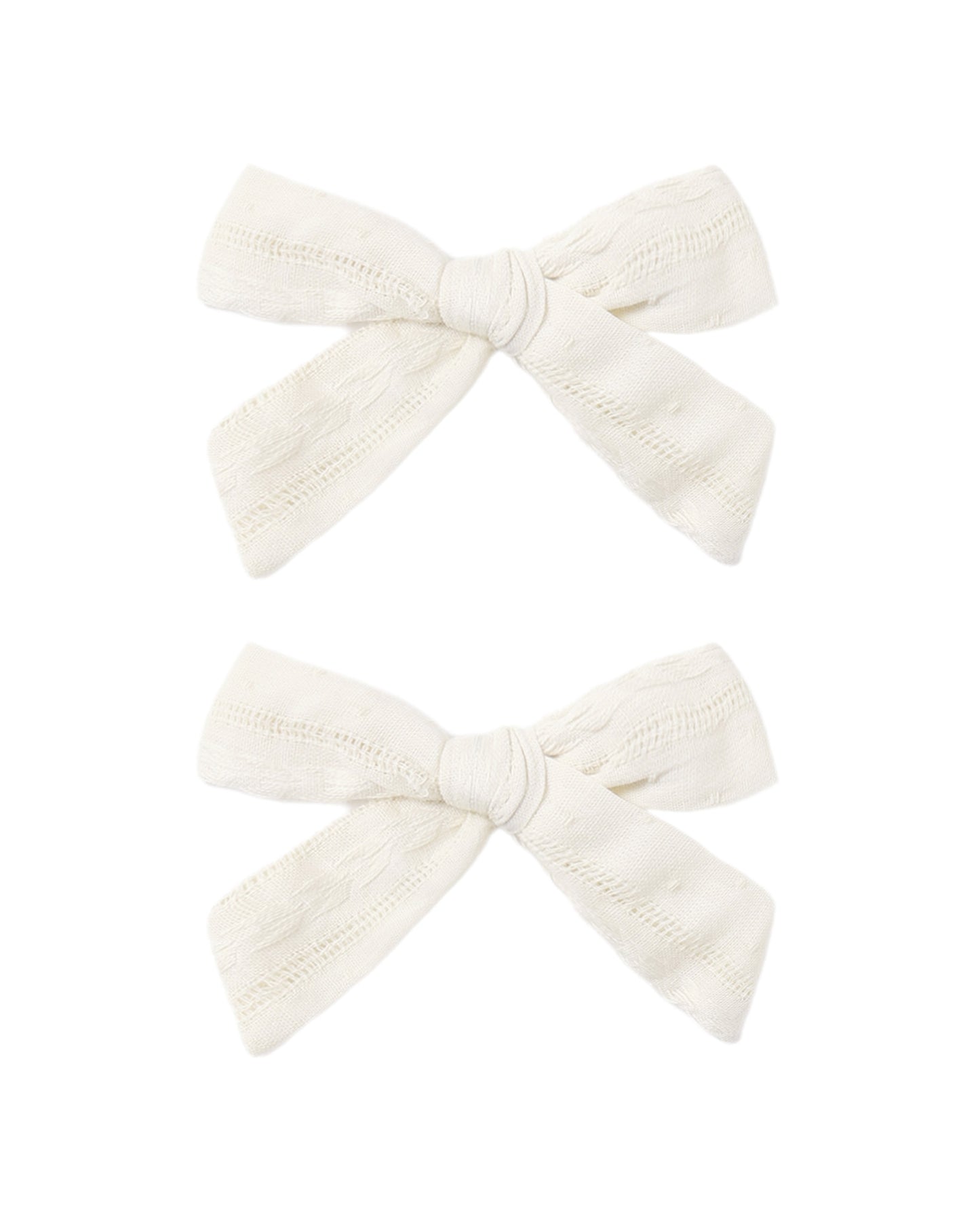 Set of two ivory bows from Rylee & Cru, featuring soft fabric and adorable, versatile hair accessories for children.