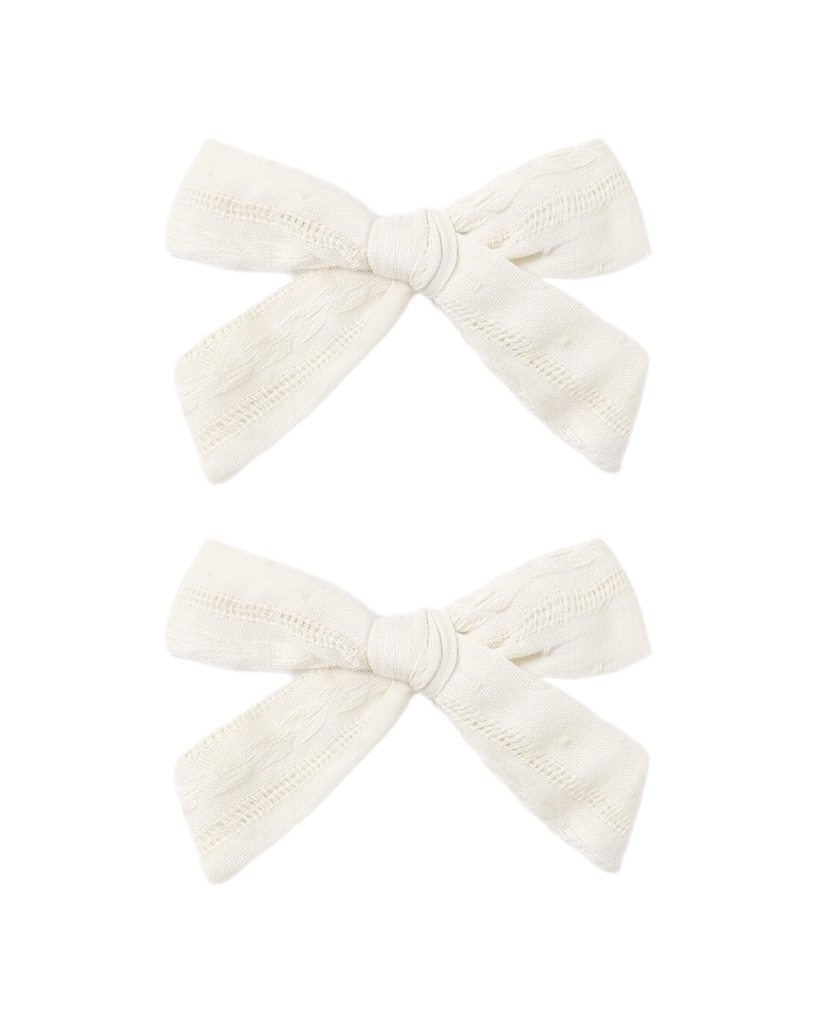 Set of two ivory bows from Rylee & Cru, featuring soft fabric and adorable, versatile hair accessories for children.