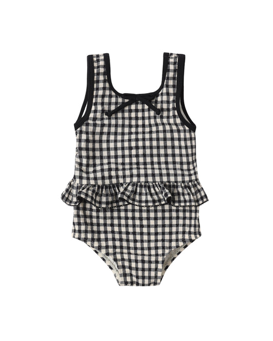 Black gingham skirted one-piece swimsuit by Rylee & Cru, featuring a cute, adjustable tie front and ruffled skirt detail.