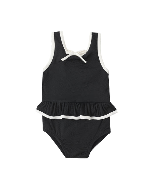 Black skirted one-piece swimsuit by Rylee & Cru featuring a sleek design with a fitted silhouette and shoulder straps.